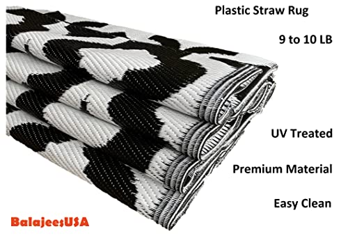 Outdoor Plastic Straw patio Rug in black & white Colour of BalajeesUSA brand  folded and kept 