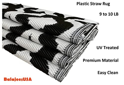 Outdoor Plastic Straw patio Rug in black & white Colour of BalajeesUSA brand  folded and kept 